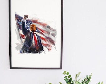 May include: A framed art print featuring a watercolor-style illustration of Donald Trump with a raised fist, wearing a dark suit and red tie, set against a stylized, flowing American flag background with red, white, and blue colors.