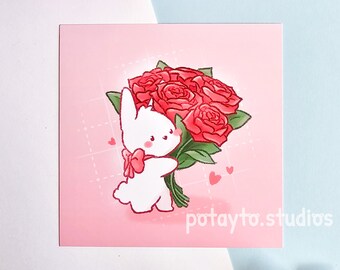 May include: A white bunny holding a bouquet of red roses with green stems and leaves. The bunny is wearing a pink bow. The background is pink with a white grid pattern and small pink hearts.