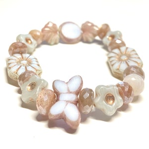 White and pink Czech glass Picasso butterfly bead bracelet adorned by white with pink & light copper wash flowers and pink faceted beads.