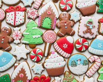 May include: Assortment of Christmas-themed sugar cookies decorated with various designs, including trees, candy canes, gingerbread houses, snowmen, and ornaments. The cookies are arranged on a white surface with the text "Little Bird Art Cookie Studio LLC" in the bottom right corner.