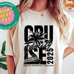 May include: Ivory-colored t-shirt with a black graphic design. The design features the word "CRUISE", "Family", and "2025" with a palm tree and a cruise ship illustration. The text "MAKING MEMORIES TOGETHER" is also included.