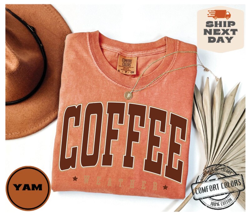 May include: A peach-colored t-shirt with the word "COFFEE" printed in brown letters. The shirt has a distressed look and is made of 100% cotton.