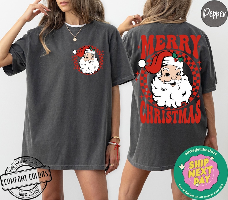 May include: A gray t-shirt with a red and white retro design featuring a cartoon Santa Claus with the text "Merry Christmas".