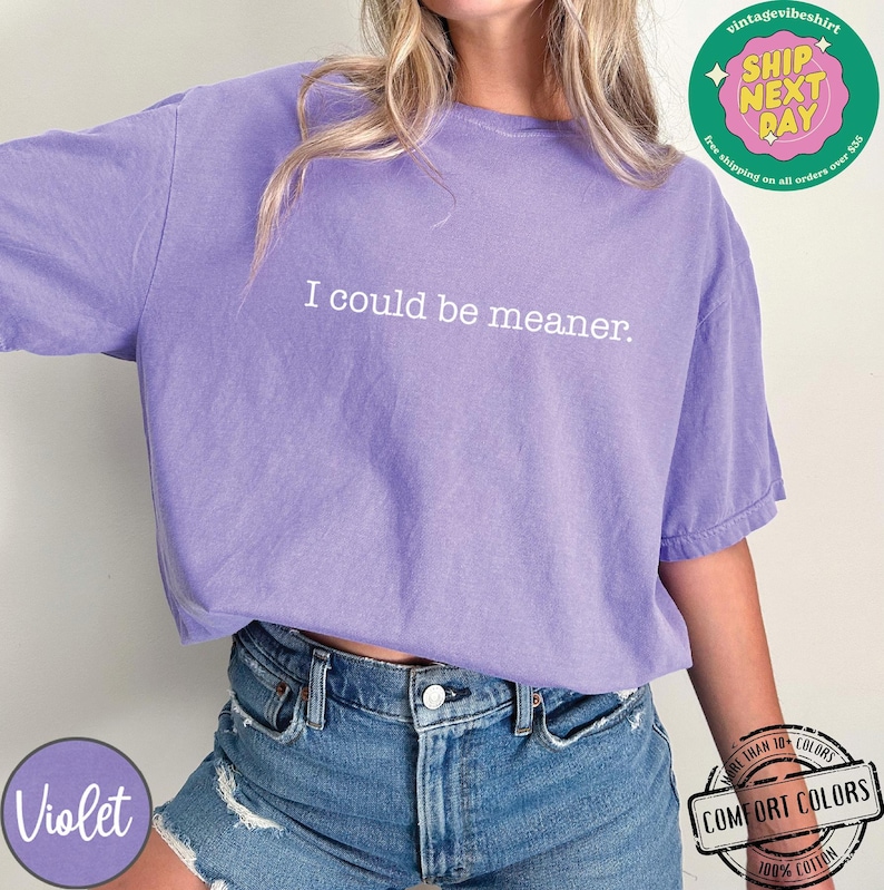 May include: Violet-colored t-shirt with the text "I could be meaner." The shirt is made of 100% cotton and has a Comfort Colors label. The shirt is part of the Vintage Vibes collection.