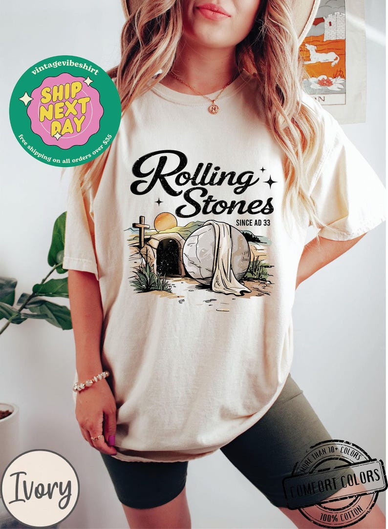 May include: A white t-shirt with a graphic of a stone tomb with a cross and the text "Rolling Stones Since AD 33".