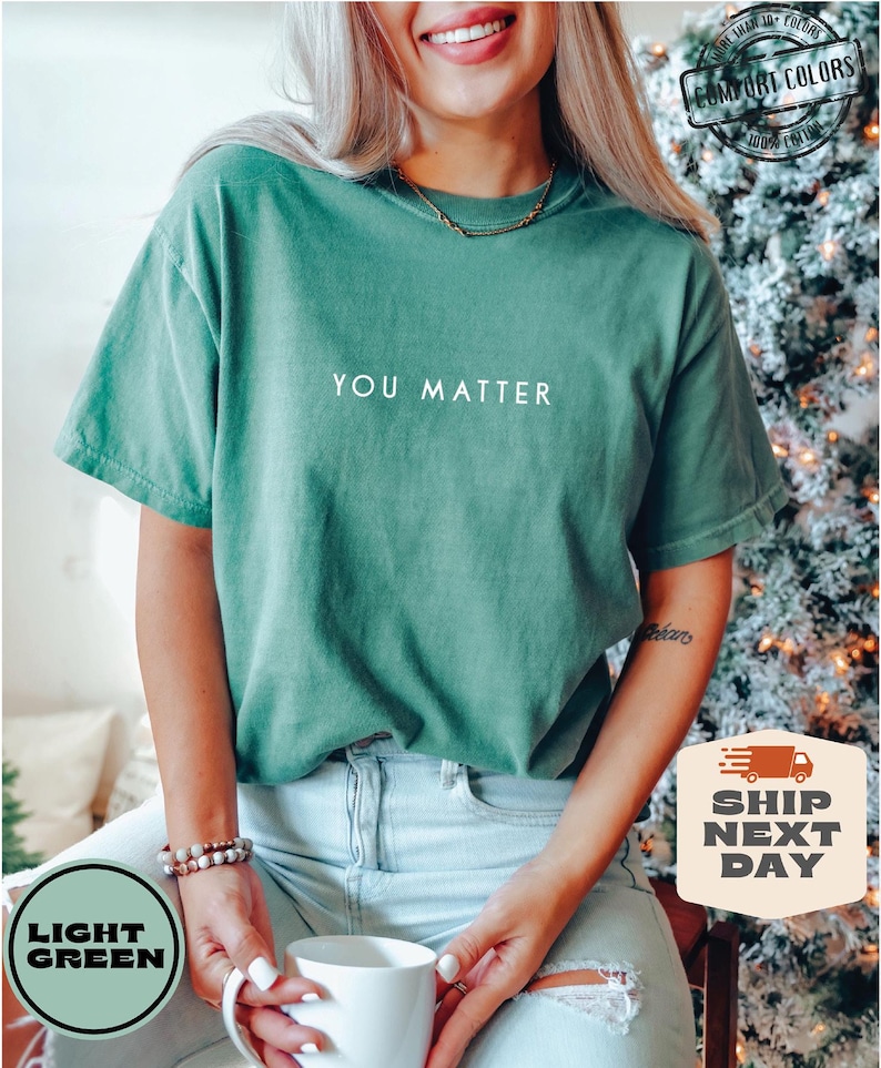 May include: A light green t-shirt with the text "YOU MATTER" printed in white on the front.