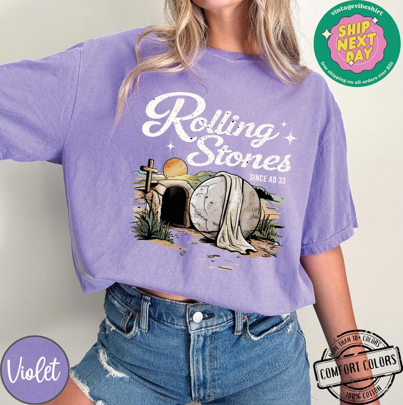 May include: Purple t-shirt with a graphic of a stone rolling away from a tomb with the text "Rolling Stones Since AD 33".