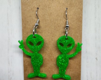 Cute alien giving peace sign glittery resin dangling earrings