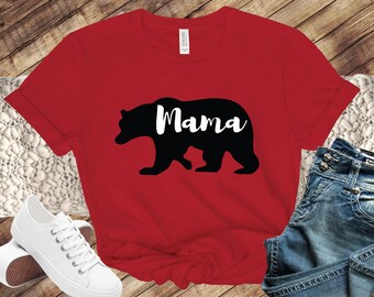 May include: Red t-shirt with a black silhouette of a bear and the word "Mama" in white text.