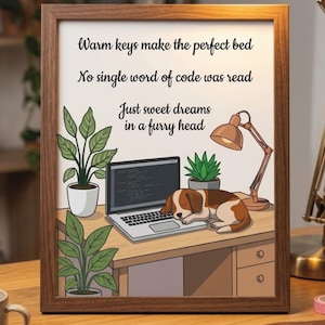 May include: A framed print featuring a brown and white puppy sleeping on a laptop keyboard on a desk with two potted plants and a desk lamp. The text reads: Warm keys make the perfect bed, No single word of code was read, Just sweet dreams in a furry head.