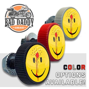 May include: Three motorcycle license plate bolts with a yellow smiley face design and a red blood splatter. The bolts are available in black, red, and gray.