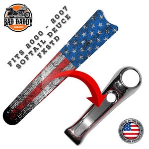 May include: An American flag-themed motorcycle part with a distressed design. The part is a long, narrow shape with a blue star field and red and white stripes. A chrome-finished motorcycle part is also shown. The text reads "FITS 2000 - 2007 SOFTAIL DEUCE FXSTD".