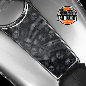 May include: A black and white skull pattern gas tank decal with the text "Bad Daddy Garage".