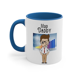 May include: White ceramic mug with a blue rim and handle. The mug features a cartoon illustration of a man wearing a red tie and glasses, with the text "Map Daddy" above him.