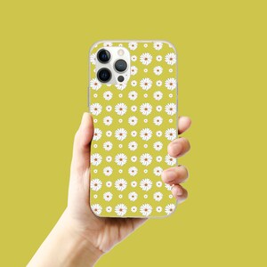 May include: A yellow phone case with a white daisy pattern. The case has a camera lens cutout and a white border.