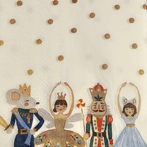 May include: A white background with gold polka dots features four characters from the Nutcracker ballet. A mouse king in a blue and red uniform, a ballerina in a gold dress, the Nutcracker in a red and green uniform, and a ballerina in a blue dress.