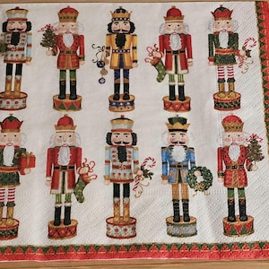 May include: A set of ten colorful nutcracker figurines with various designs and poses. The nutcrackers are all wearing traditional costumes and hats. They are arranged in two rows of five on a white background with a red and gold border.
