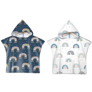 May include: Two hooded towels with rainbow patterns. One towel is navy blue with white, yellow, and pink rainbows. The other towel is white with blue, pink, and yellow rainbows.