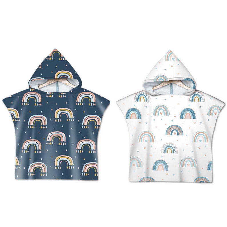 May include: Two hooded towels with rainbow patterns. One towel is navy blue with white, yellow, and pink rainbows. The other towel is white with blue, pink, and yellow rainbows.