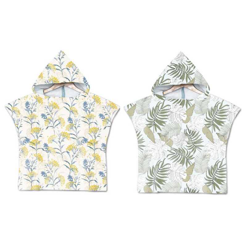 May include: Two hooded towels with different patterns. One towel has a floral pattern with yellow, blue, and white flowers. The other towel has a tropical leaf pattern with green and white leaves.