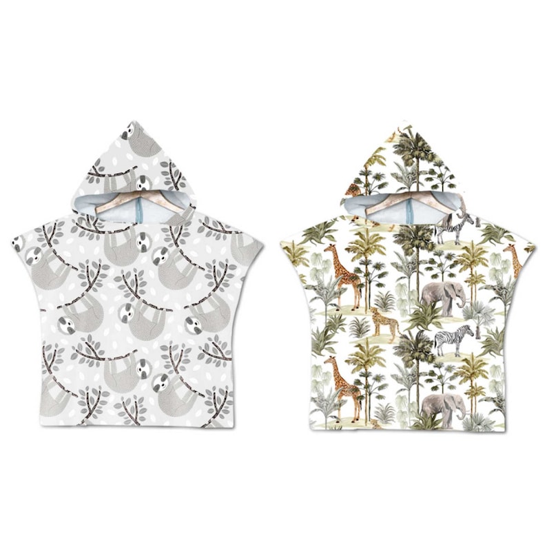 May include: Two hooded towels with different animal prints. One towel features a grey and white sloth print, while the other features a white background with giraffes, zebras, elephants, and palm trees.