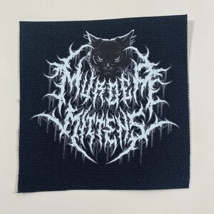 May include: Black and white embroidered patch with a black cat's head and the text "MISANTHROPIC" in a stylized font.