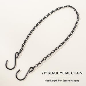 May include: A 23-inch black metal chain with two S-hooks for hanging. The chain is made of metal and is designed for secure hanging. The text "23" BLACK METAL CHAIN" is visible.