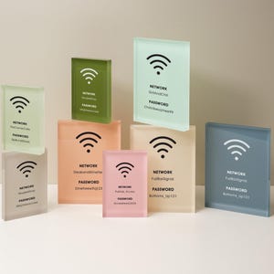 May include: A collection of rectangular glass blocks in various pastel colors, each displaying a Wi-Fi symbol and network information. The blocks have text indicating network names and passwords, ideal for home or office use.