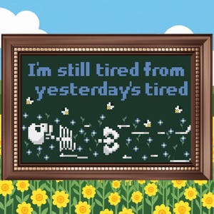 May include: A framed cross-stitch piece with the text "I'm still tired from yesterday's tired" in blue. The design includes a skeleton, bees, and flowers on a dark green background, set against a floral and sky backdrop.