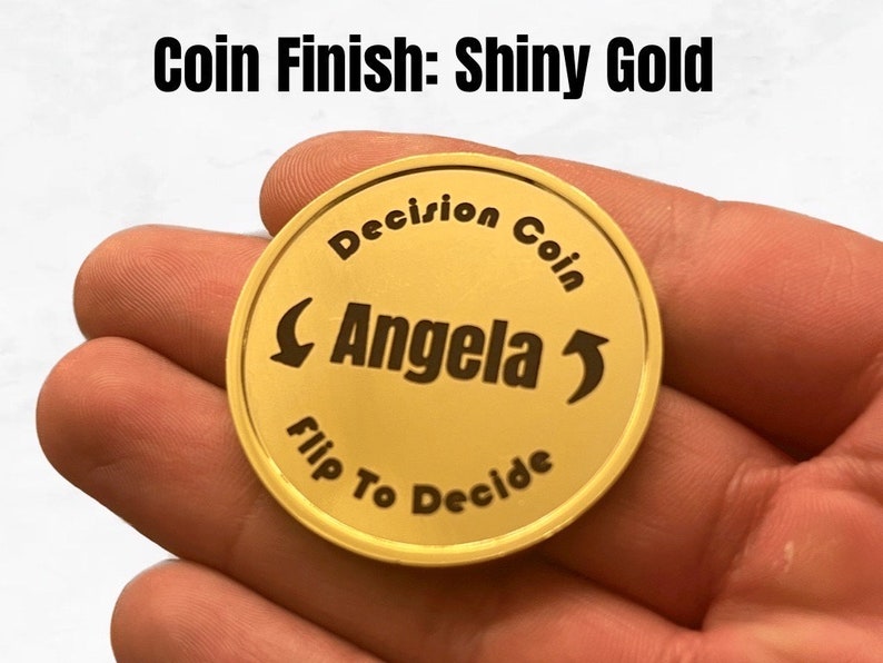 May include: Shiny gold coin with the text "Decision Coin" and "Flip To Decide" around the edge. The name "Angela" is in the center with arrows pointing left and right.