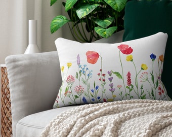 May include: White throw pillow with a watercolor design of colorful wildflowers, including red poppies, on a white background.