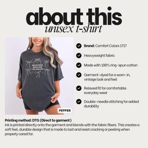 May include: A charcoal grey t-shirt featuring a white graphic print of six bows surrounding the text REGISTERED BEHAVIOR TECHNICIAN. The shirt has a crew neckline, short sleeves, and a relaxed fit. The text about this unisex t-shirt is visible.