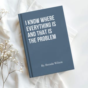 May include: A slate blue hardcover book with white text that reads I KNOW WHERE EVERYTHING IS AND THAT IS THE PROBLEM, followed by the author name By Brenda Wilson printed in a smaller white font at the bottom of the front cover.