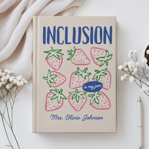 May include: A beige hardcover book with the blue text INCLUSION at the top and Mrs. Olivia Johnson at the bottom. The cover features a pattern of pink strawberries with green leaves and a blue oval containing the text is my jam.