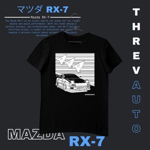 May include: Black t-shirt with a white graphic of a Mazda RX-7 sports car. The car is outlined in white and is driving on a white and black checkered background. The text "THREVAUTO" is printed in white on the bottom right corner of the graphic. The text "MAZDA RX-7" is printed in white on the bottom of the t-shirt.