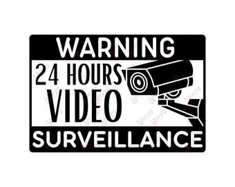 Peut inclure: Un panneau d'avertissement noir et blanc avec le texte "WARNING 24 HOURS VIDEO SURVEILLANCE" et une silhouette de caméra de sécurité.
