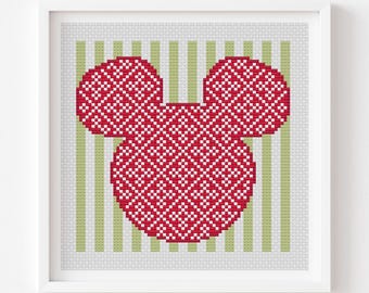 May include: A framed cross-stitch pattern featuring a red and white Mickey Mouse head design. The background has green and white vertical stripes. The text "Norwegian Mickey gift 3" is at the top, and "cross stitch pattern PDF pattern" is at the bottom.