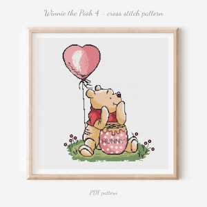 May include: Cross-stitch pattern featuring Winnie the Pooh with a heart-shaped balloon. The bear is dressed in a red shirt and sits beside a honey pot. Text reads "Winnie the Pooh 4 - cross stitch pattern" and "PDF pattern".