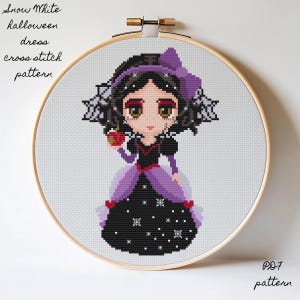 May include: A cross-stitch pattern of Snow White in a Halloween dress, held in a wooden embroidery hoop. The design features a cartoon Snow White with a black dress, purple accents, and an apple. Text includes "Snow White", "halloween", "dress", and "cross stitch pattern".