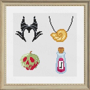 May include: Cross-stitch art featuring four designs: a black horned headdress, a gold seashell necklace, a green and red poison apple, and a potion bottle with a pink label. The designs are set against a white background within a framed presentation.