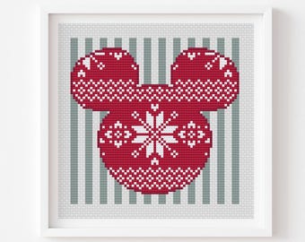 May include: Framed cross-stitch pattern featuring a red Mickey Mouse head with a white snowflake design. The background has vertical gray and white stripes. The text "Norwegian Mickey gift 2" is at the top.