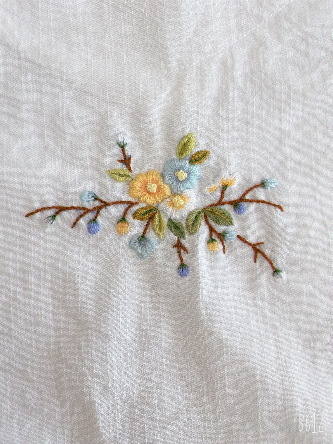 White shirt with colorful embroidered flowers