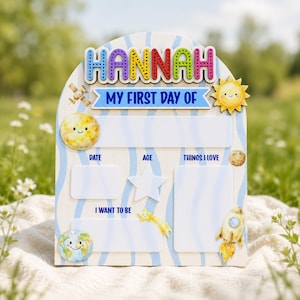 May include: An arched wooden sign with a light blue wavy pattern featuring the name HANNAH in colorful letters. It includes the text MY FIRST DAY OF, DATE, AGE, THINGS I LOVE, and I WANT TO BE, with illustrations of a satellite, sun, moon, rocket, and earth.