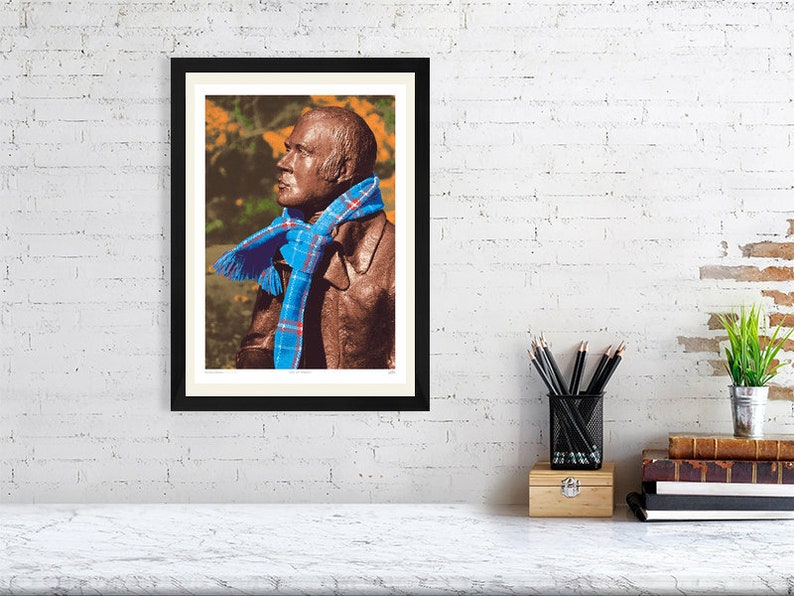 ‘Hap Up, Rabbie!’ art print, A3 size, mounted and framed, shown on a wall. A statue of Scots bard Robert (Rabbie) Burns with a colourful scarf wrapped around it.