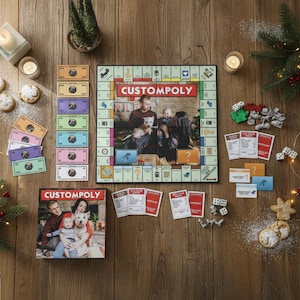 May include: A custom Monopoly board game with family photos, game pieces, dice, and play money. The board game box and board are labeled "CUSTOMPOLY". The scene is set on a wooden surface with festive decorations.