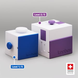 May include: Two white cube puzzles with coloured panels. One has blue and white, the other purple and white. The puzzles are labelled "keebox", with "Level 1/5" and "Level 2/5" also visible. Swiss Made logo is in the corner.