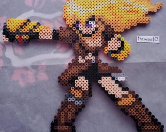 May include: A pixel art figure of a character with blonde hair and brown clothing, made from colorful plastic beads. The figure is in a dynamic pose, with one arm extended as if firing a weapon. The text "thewade102" is visible.