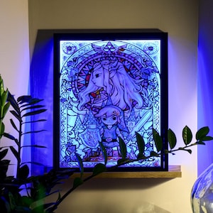 Puede incluir: Una obra de arte de estilo vitral que presenta a un personaje femenino con cabello largo y rubio y un personaje masculino con una t&uacute;nica verde y una espada. La obra est&aacute; enmarcada en negro e iluminada con luz azul.