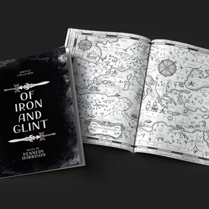 May include: A black and white book with the title "Of Iron and Glint" and the author "Kennedy Harrison". The book is open to a page with a detailed black and white map.