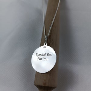 May include: Silver necklace with a round pendant that says "Special Tex For You" on the back. The pendant is 925 silver.